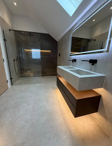 Shower and double vanity under a skylight with LED mirror lighting