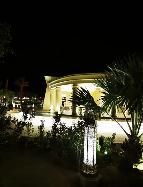 Illuminated house exterior and garden lighting at night, electrical work in Warrington