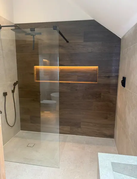 Walk-in shower with an LED lit tiled niche